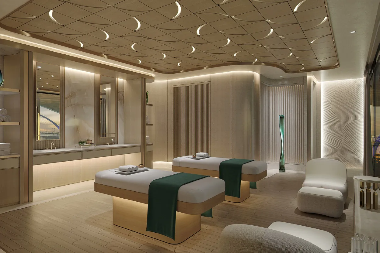 Spa treatment room with two massage beds and a carved timber ceiling